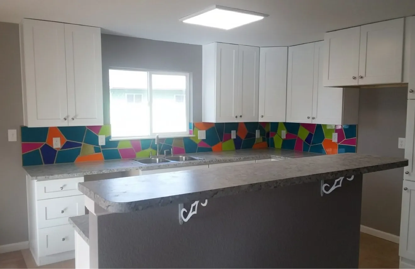 Colorful geometric hand-cut glass mosaic backsplash