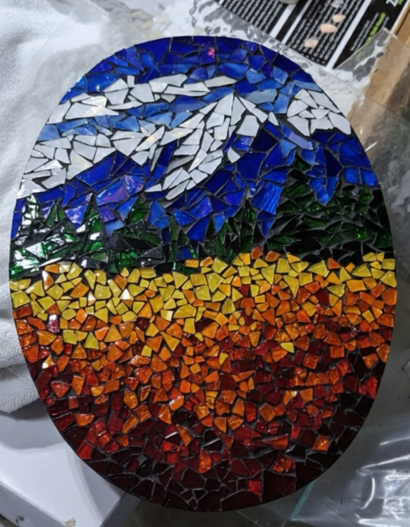 Oval sunset hand-cut mountain mosaic, framed